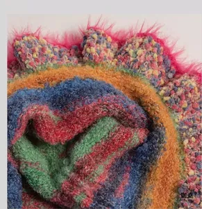 Macro shot of colorful bouclé knit texture with vibrant faux fur trim and striped yarn