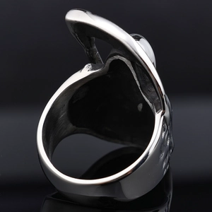 Macro shot of silver stainless steel ring featuring intricate gothic death skull engravings