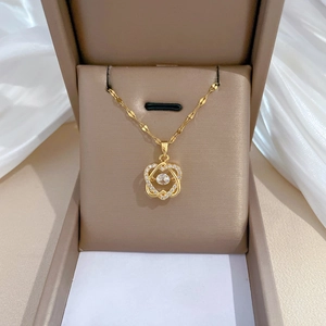 Luxurious gold heart-shaped zircon necklace on a satin background in jewelry box