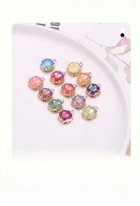 Detailed view of colorful square crystal charms with golden hollow metal frames