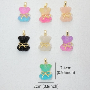 Detailed size view of colorful gummy bear charms with sugar texture and golden bows