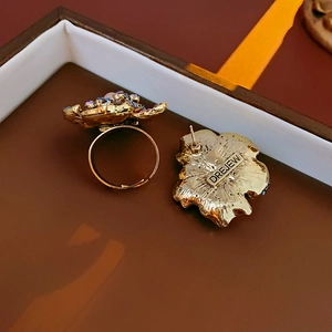 Close-up of vintage golden flower jewelry set with pink and blue gemstones