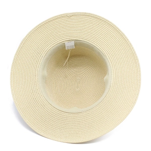 Detailed view of the interior 100% paper material and wash label of the straw sun hat