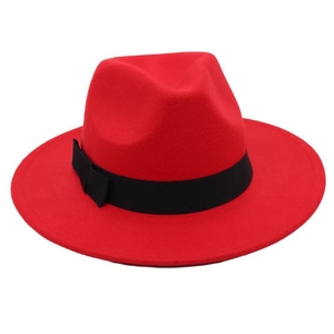 Detailed view of red wool felt fedora featuring a wide black ribbon and structured brim