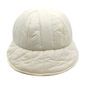 Close-up of cream quilted down bucket hat showing vertical stitching and padded texture