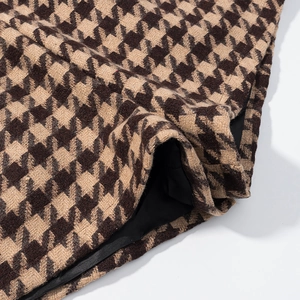 Macro view of brown and beige houndstooth fabric texture with black lining detail