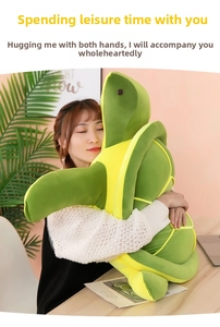 Detailed view of a soft plush sea turtle pillow being held to show large size and texture