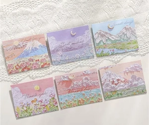 Artistic textured greeting cards with floral landscape designs on white lace fabric