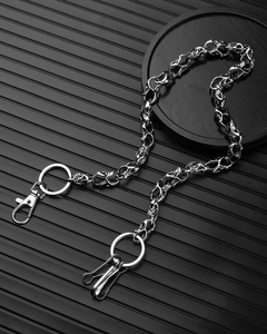 Detail of gothic punk metal trouser chain with metallic skull charms and clasp fasteners