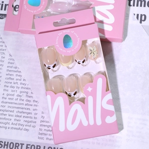 Short round French press-on nails with 3D floral accents and leopard bow designs