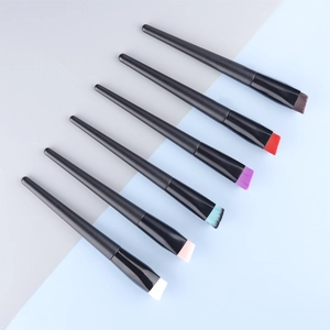 Macro shot of 6 professional flat slanted makeup brushes with colorful synthetic bristles