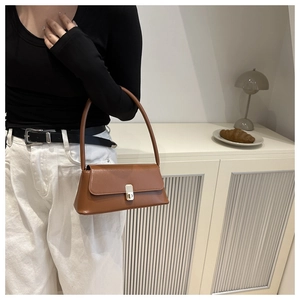 Brown PU leather baguette bag featuring a silver metal clasp shown on a model