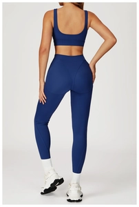 Rear view of dark blue high-waist yoga leggings and sports bra with lift-up seams