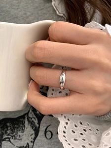 Close-up of s925 silver smile letter ring featuring an irregular vintage design on finger