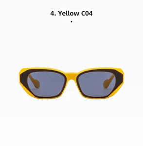Detail of cat-eye sunglasses featuring bold yellow and brown two-tone frame and grey lenses