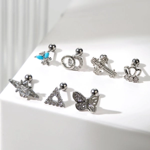 Set of surgical steel cartilage earrings with butterfly, cross and star zircon designs