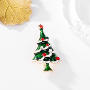 Detail of a Christmas tree brooch with green enamel and vibrant sparkling rhinestones
