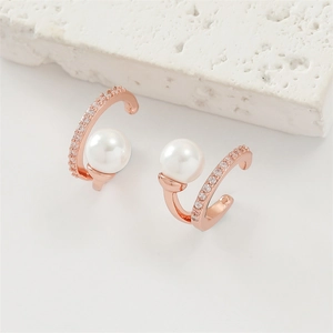 Detailed macro view of rose gold ear cuff with large pearl and sparkling zircon rows