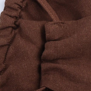 Detail of dark brown linen dress featuring an elastic waistband and fine stitching