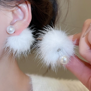 Close-up of white plush ball and pearl earrings showing the layered front-back design