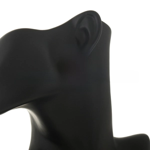 Close-up of golden spiral knot stud earring on a black display model for scale