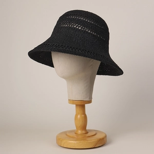 Women's black hollow knit sun hat with wide brim on elegant display mannequin stand