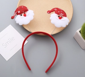 Detail of Christmas headband with Santa Claus spring design on grey festive tabletop