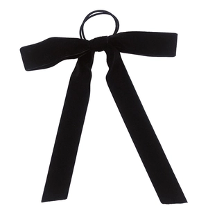 Elegant black velvet bow hair scrunchie with long ribbons on a white background