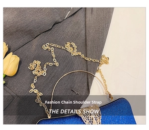 Blue glitter evening clutch featuring a gold ring handle with intricate floral carvings