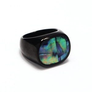 Polished black stainless steel ring featuring an oval iridescent abalone shell inlay