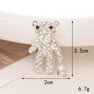 Detail view of a bear shoe charm with rhinestones and clear teardrop pendant