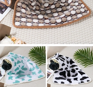 Detail of soft flannel pet blanket edging with adorable pugs in different patterns