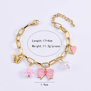 Detail of gold chain bracelet with pink flower, bow, heart charms and white pearl