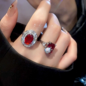 Close-up of luxury red ruby rings with micro-pave crystals on a silver band