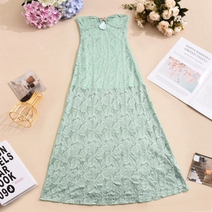 Detailed close-up of mint green floral lace texture on a strapless summer maxi dress