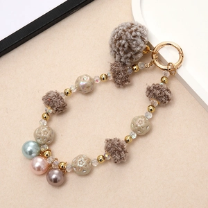 Colorful beaded keychain with faux fur pom pom and golden hook for bags or phones