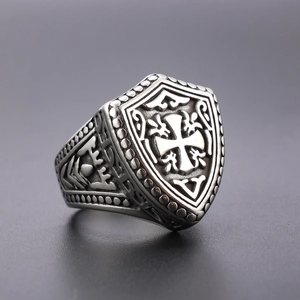 Detail showing vintage silver cross signet ring with shield shape and antique engravings