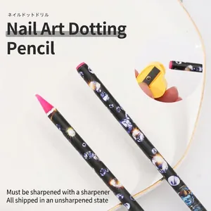 Nail art dotting pencil set with pink wax tip, tweezers and sharpener on a white plate