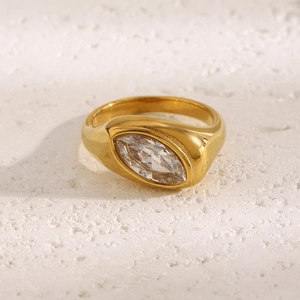 Macro shot of gold-plated chunky ring featuring a large marquise-cut clear gemstone detail
