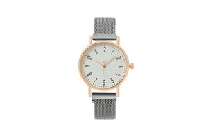 Detailed close-up of rose gold women's watch with white dial and grey mesh magnetic band