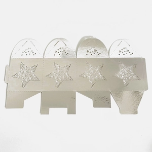 Flat lay of flat-pack silver gift box with laser-cut stars and heart-shaped closure