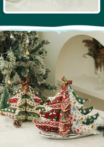 Macro shot of fabric Christmas tree ornaments with festive patterns and golden bells