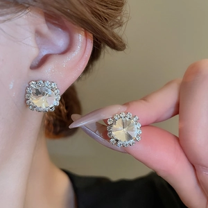 Detailed view of silver stud earrings with sparkling round cubic zirconia stones