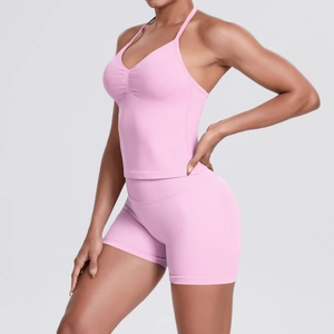 Detail view of pink seamless high-waist yoga shorts and V-neck sports bra set