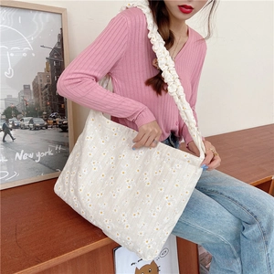 Detail of daisy canvas tote bag with cloud-like ruffled shoulder strap and floral print