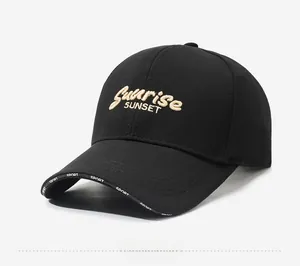 Detail of black baseball cap featuring Sunrise Sunset embroidery and Sport print on brim