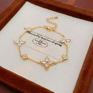 Detailed shot of gold-plated flower bracelet with sparkling zircons on jewelry box