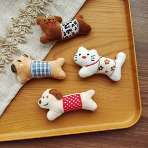 Detailed view of plush animal brooches featuring cartoon dogs and cats in varied patterns