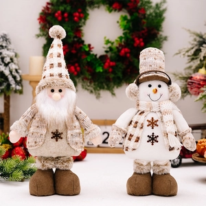 Close-up of Santa and Snowman plush dolls with telescopic legs in festive Xmas decor