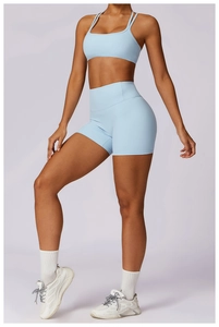Detail of light blue high-stretch yoga set with cross back bra and high-waist shorts